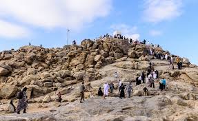 Pilgrims visiting historic Islamic sites in Makkah and Madinah, including Masjid an-Nabawi, Mount Uhud, and Masjid al-Haram in a spiritual travel collage